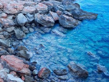 High angle view of rocks in sea