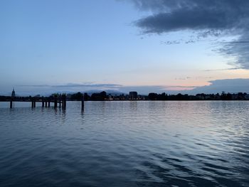 Scenic view of lake against sky at sunset