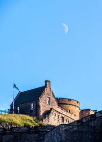 Low angle view of old building against blue sky