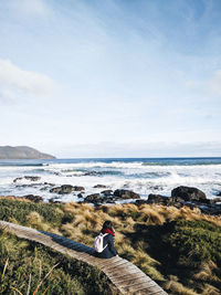 Man looking at sea against sky