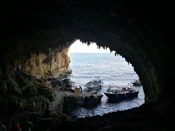 Scenic view of sea seen through cave