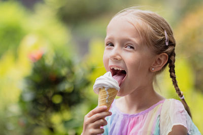 Portrait of smiling girl blowing outdoors