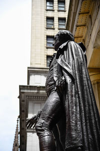 Low angle view of statue against building