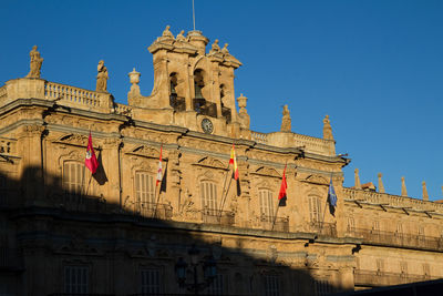Low angle view of historical building against blue sky. main square in salamanca.