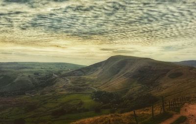 Scenic view of mountains against cloudy sky