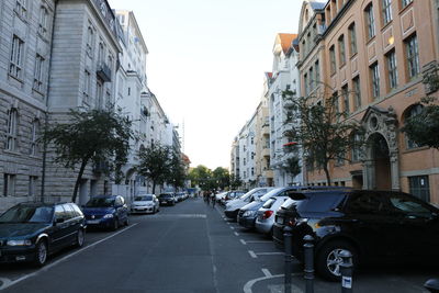 Cars on street amidst buildings in city