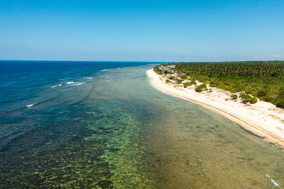 Wide sandy beach with ocean surf and waves. philippines.