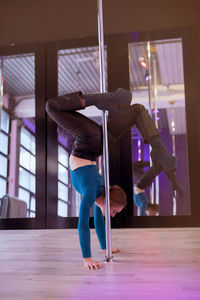 Low section of woman exercising in gym