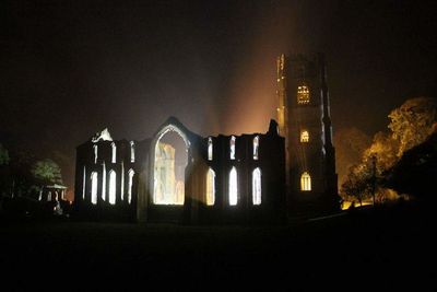 Illuminated church against sky at night