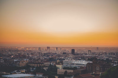 High angle view of buildings against sky during sunset