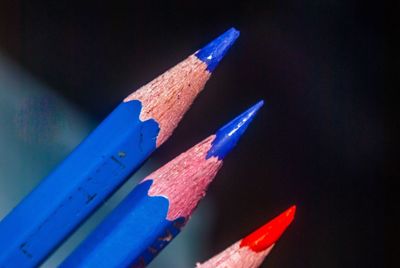 Close-up of colored pencils against blue background