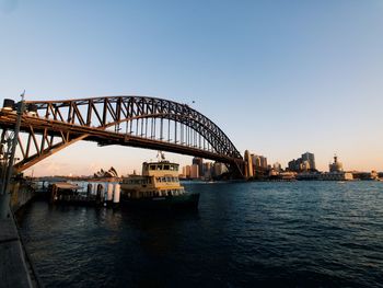 View of bridge over river at sunset