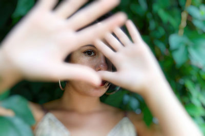 Woman hiding her face under her hands