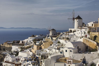 Panoramic view of buildings by sea against sky