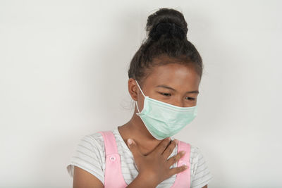Portrait of a young woman against white background