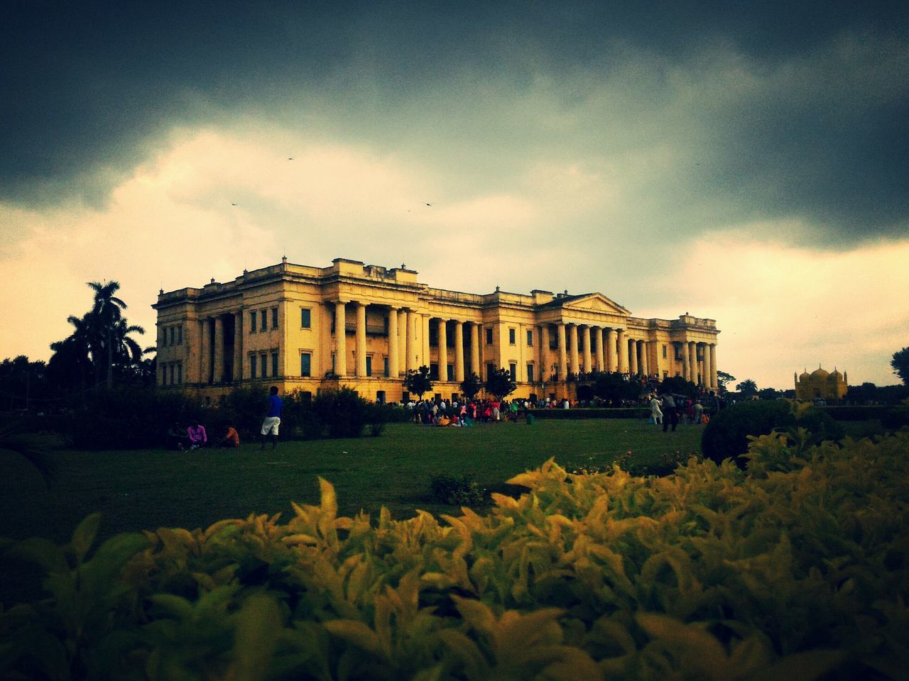 architecture, built structure, building exterior, sky, cloud - sky, large group of people, grass, cloudy, cloud, travel destinations, history, person, men, facade, famous place, tourism, lawn, outdoors, tree