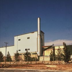 Industrial buildings against blue sky