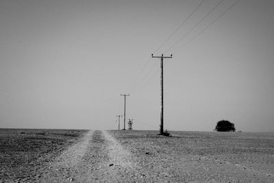 View of empty road and electric poles