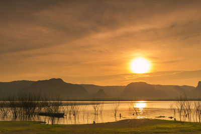 Scenic view of lake against sky during sunset