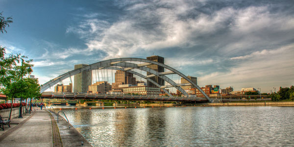 View of bridge over river against cloudy sky