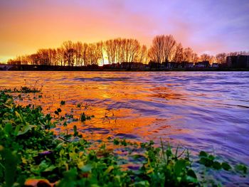Scenic view of frozen lake against sky during sunset
