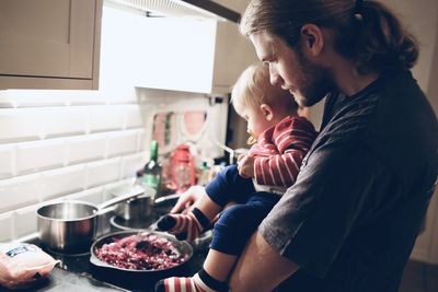 Midsection of mother and daughter at home