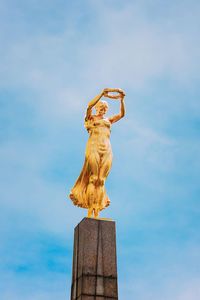 Low angle view of statue against blue sky