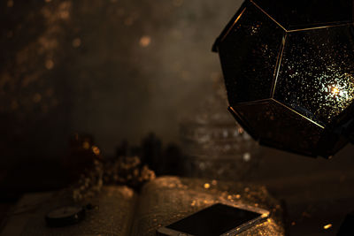Close-up of illuminated electric lamp on table