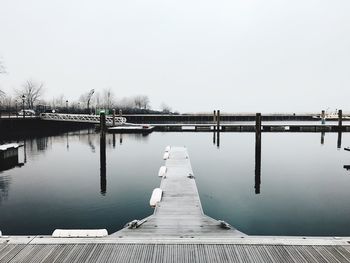 Pier over lake against clear sky