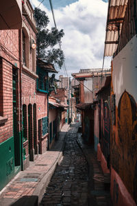 Empty alley amidst buildings in town