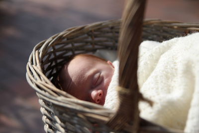 Close-up of baby sleeping in basket