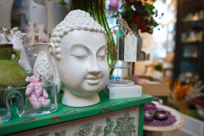 Close-up of buddha statue on table at store
