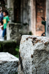 Close-up of cross on rock against temple
