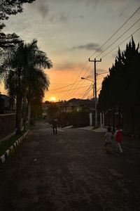 Silhouette of people at sunset