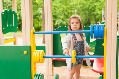 Low angle view of girl playing on slide at playground