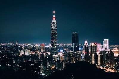 Illuminated taipei 101 against sky in city at night