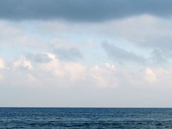 View of calm sea against cloudy sky