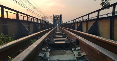 Railway bridge against sky at sunset