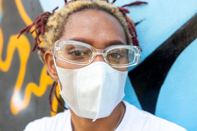 An image of a black woman wearing her blank white face mask