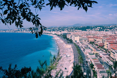 High angle view of townscape by sea against sky