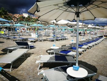 Row of chairs by water