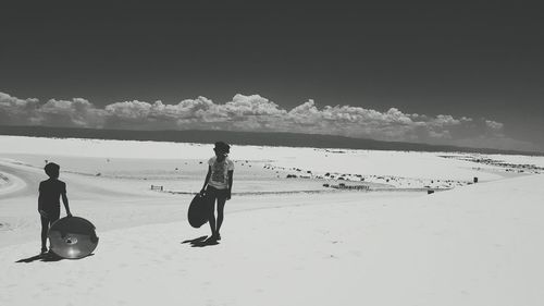 Woman standing on mountain against sky