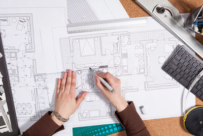 Cropped hands of woman using calculator