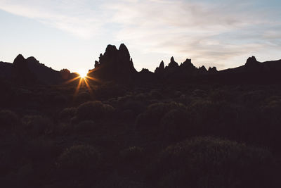 Scenic view of silhouette mountains against sky during sunset