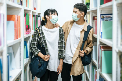 Young couple standing on book