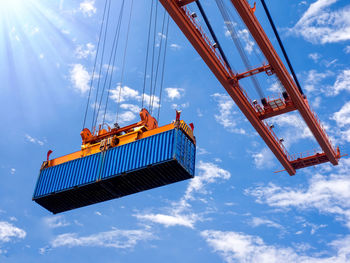 Low angle view of crane against blue sky