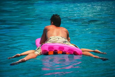 People relaxing on sea