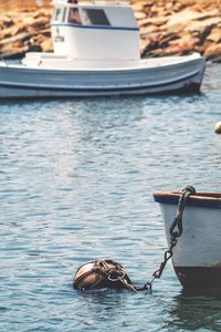 Man in boat moored on sea