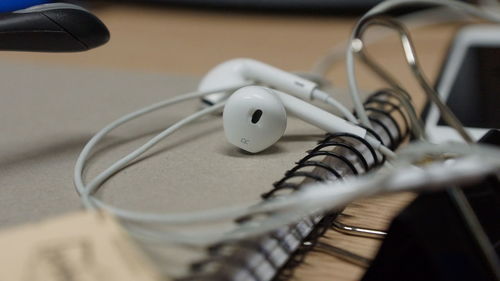 Close-up of headphones on diary