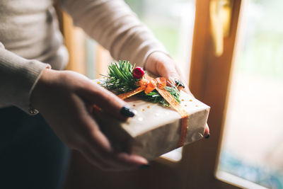 Midsection of woman holding christmas present